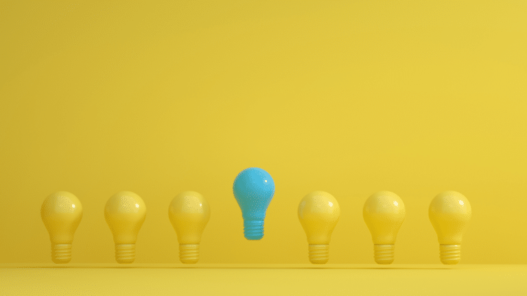 Blue and Yellow Light Bulbs horizontally in a row, with the blue light bulk in the middle and slightly higher than the others. yellow background. Christian Leadership in the Church. Church Equip